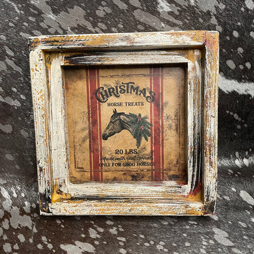 Decorative framed sign with horse illustration and text on a textured surface